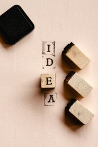 Artistic flat lay of wooden blocks spelling 'IDEA' with ink pad, perfect for DIY inspiration.